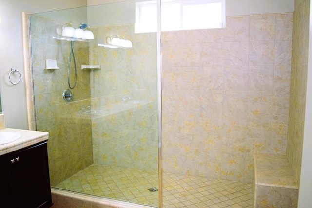 bathroom featuring vanity and tiled shower