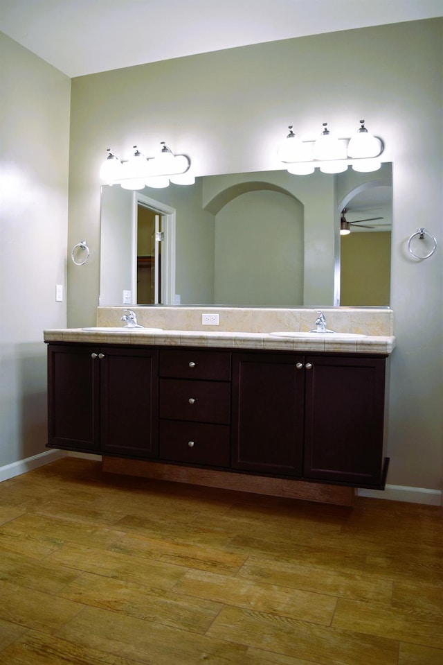 bathroom with hardwood / wood-style floors, vanity, and ceiling fan