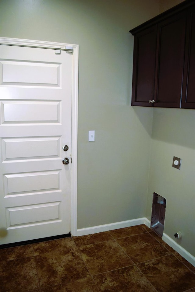 clothes washing area featuring cabinets and electric dryer hookup