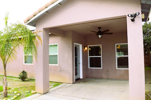 property entrance featuring ceiling fan and a patio