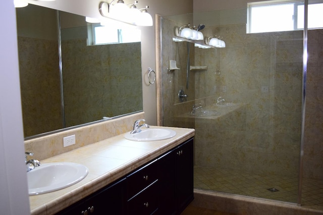 bathroom with vanity and a shower with door