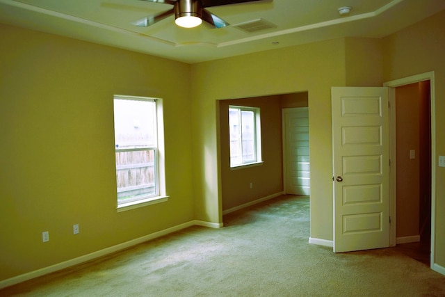 carpeted spare room featuring ceiling fan