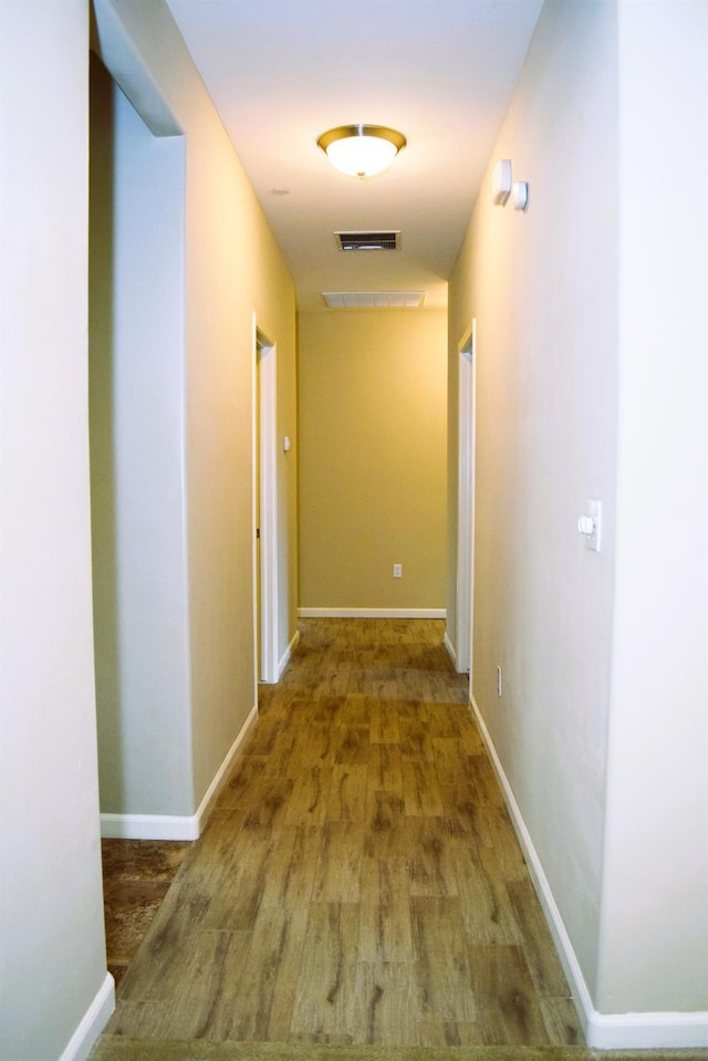 hallway with hardwood / wood-style floors