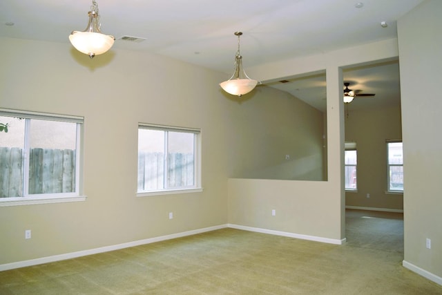 carpeted spare room with ceiling fan and lofted ceiling