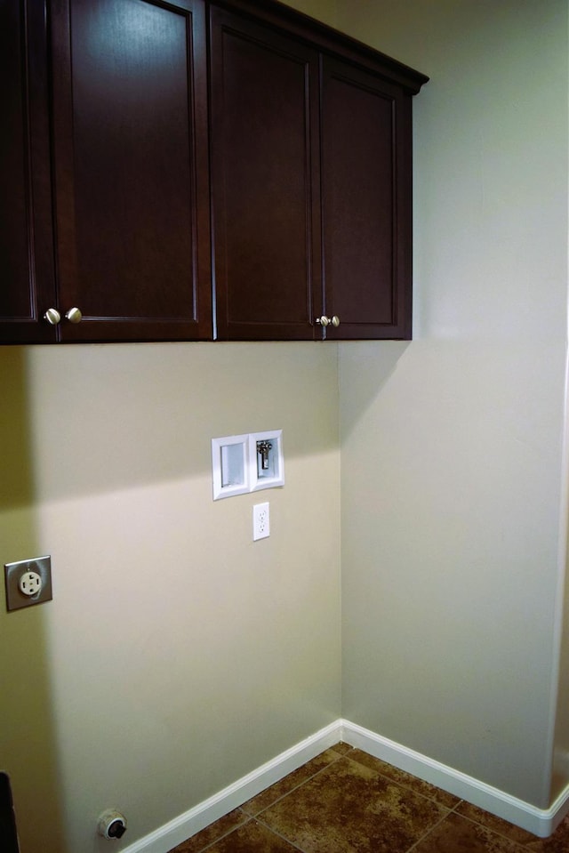 laundry area with washer hookup, electric dryer hookup, cabinets, and dark tile patterned floors