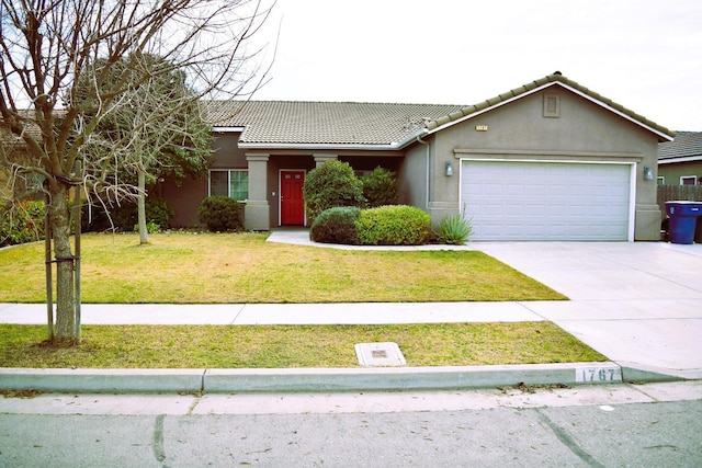 view of front of property featuring a garage and a front yard