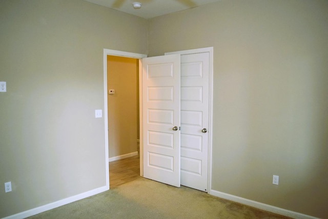 unfurnished bedroom with light colored carpet