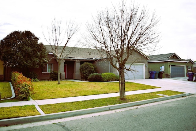 ranch-style house featuring a front yard and a garage