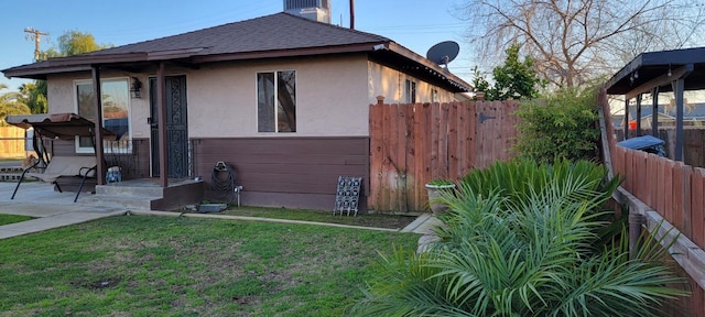 view of side of home featuring a yard