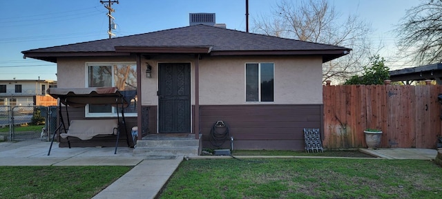 bungalow-style house with a front lawn