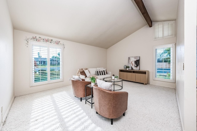 living room with lofted ceiling with beams and carpet floors