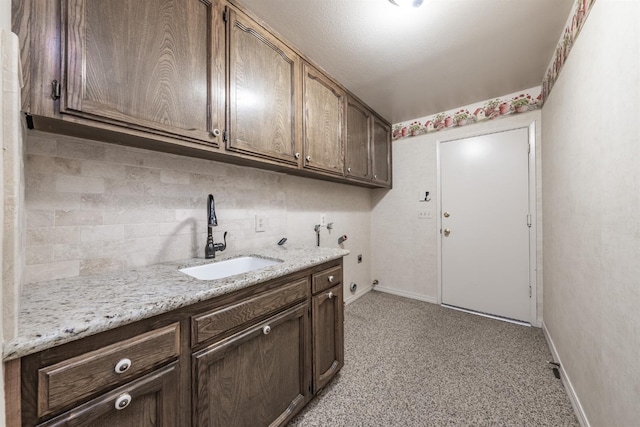 laundry room featuring sink, cabinets, and washer hookup