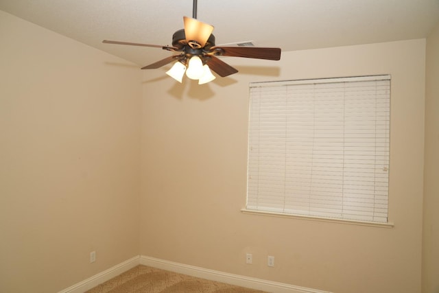 carpeted empty room featuring ceiling fan