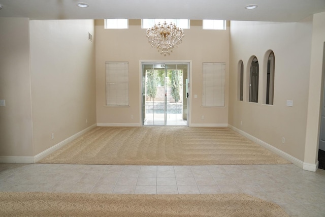 carpeted entryway featuring a chandelier