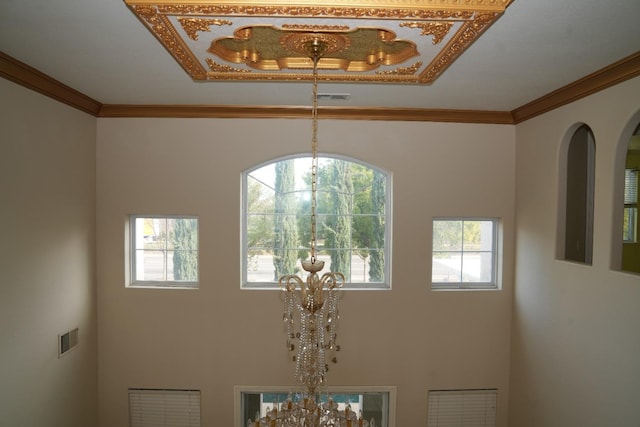 room details featuring ornamental molding and a notable chandelier