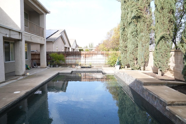 view of pool with a water view