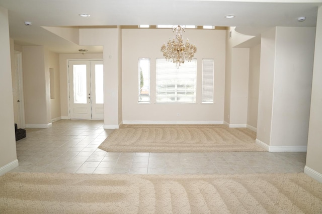 foyer entrance featuring light tile patterned flooring and a chandelier