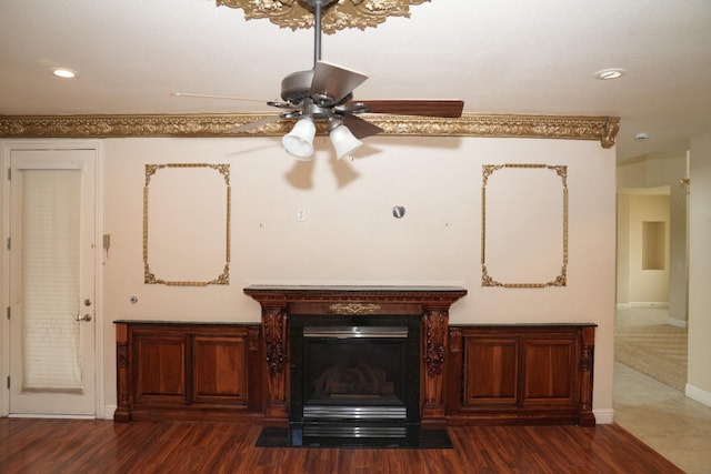 interior details with hardwood / wood-style floors, ceiling fan, and a high end fireplace