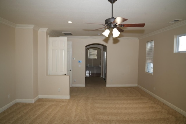 unfurnished room with light colored carpet, ceiling fan, and ornamental molding