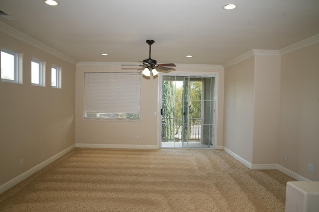 carpeted empty room featuring ceiling fan and crown molding