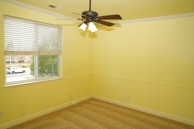 carpeted empty room with ceiling fan and crown molding