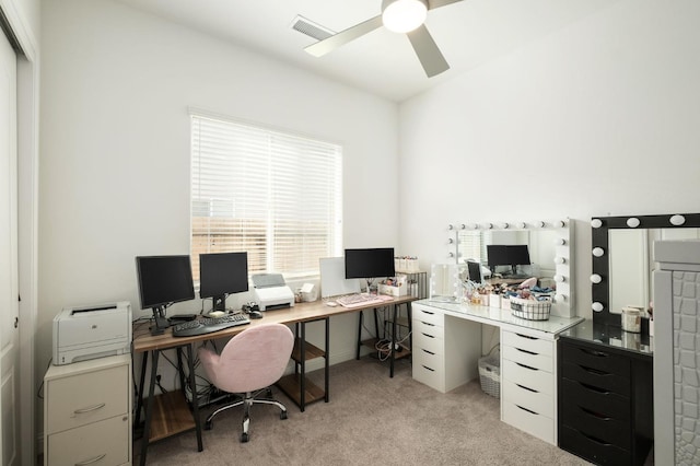 carpeted office space with ceiling fan