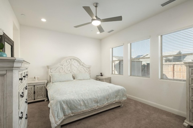 bedroom with ceiling fan and dark colored carpet