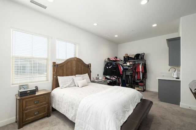 bedroom featuring light carpet