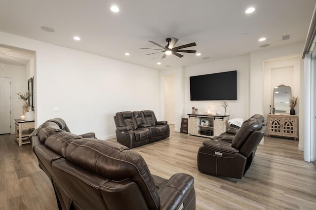 living room featuring light wood-type flooring and ceiling fan