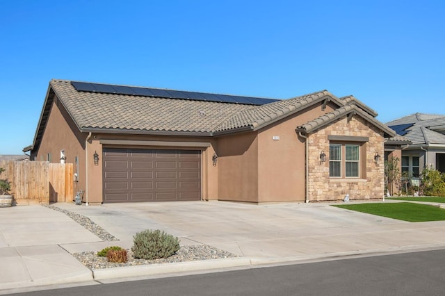 view of front of house with a garage and solar panels