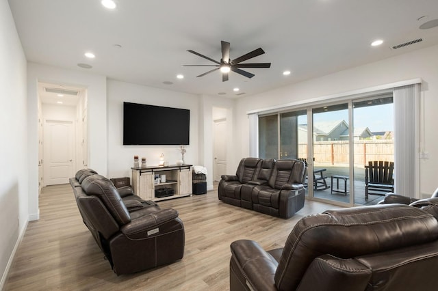 living room featuring ceiling fan and light hardwood / wood-style floors