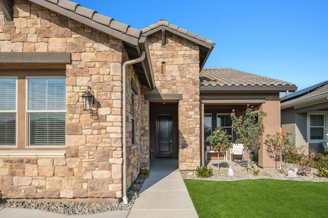 property entrance with a yard