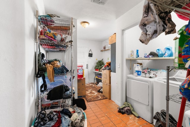 washroom with washer and dryer and light tile patterned flooring