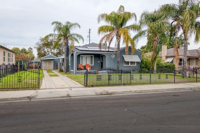 view of front of home featuring a garage, an outdoor structure, and a front yard