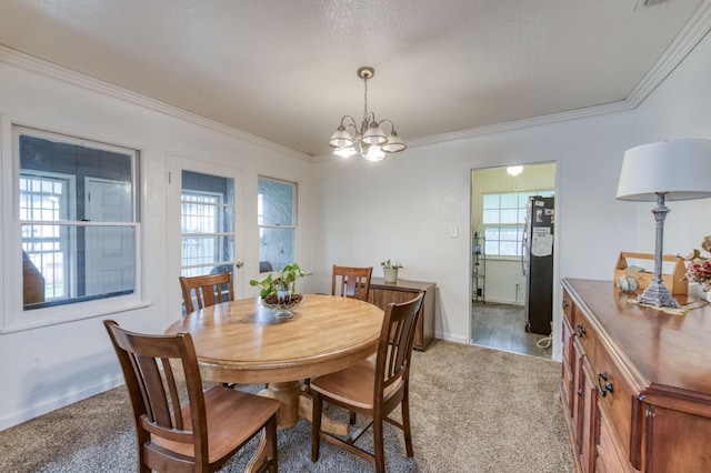 dining area featuring light colored carpet, ornamental molding, a chandelier, and a healthy amount of sunlight