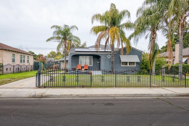 ranch-style house with a front lawn and solar panels