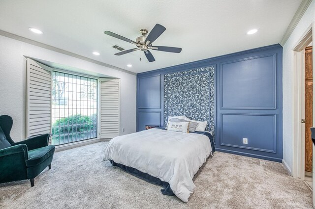 carpeted bedroom with ceiling fan and crown molding