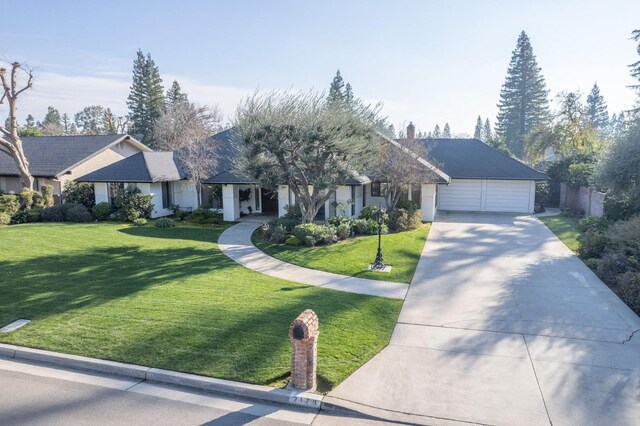 view of front of home featuring a front yard and a garage