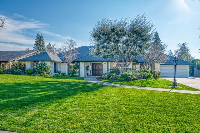 single story home with a front lawn and a garage