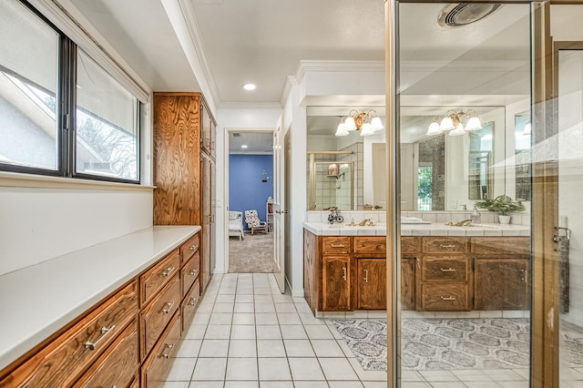 bathroom featuring vanity, tile patterned flooring, a notable chandelier, crown molding, and a shower with door