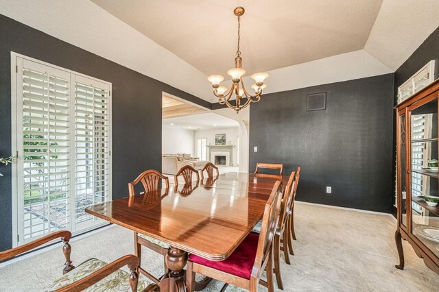 dining area featuring light colored carpet and a notable chandelier