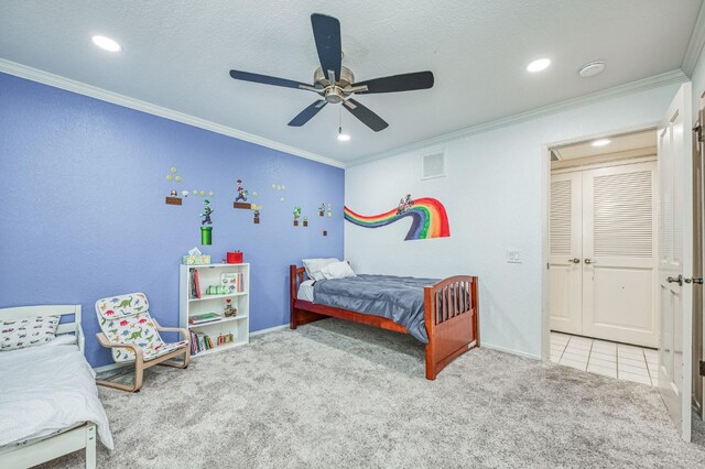 carpeted bedroom featuring ceiling fan and crown molding