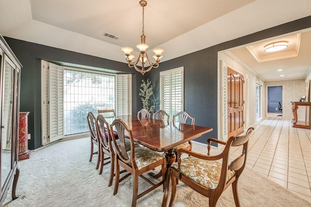 dining space with light carpet, a chandelier, ornamental molding, and a raised ceiling