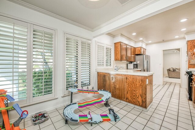 kitchen featuring black electric range, kitchen peninsula, stainless steel refrigerator, ornamental molding, and light tile patterned floors