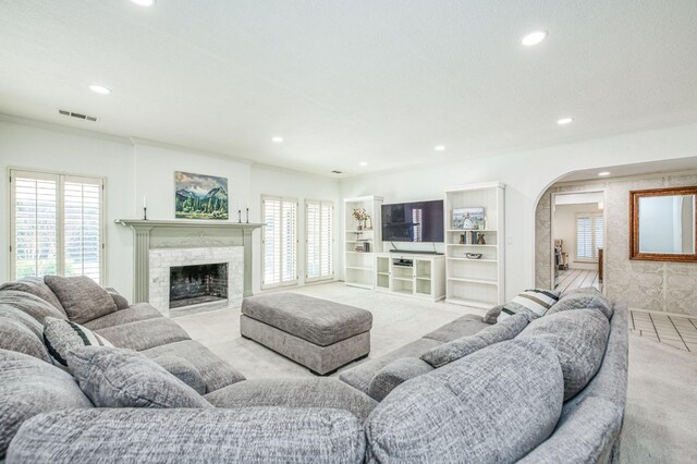 carpeted living room featuring a fireplace