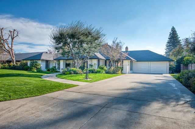 ranch-style home with a front yard and a garage