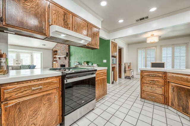 kitchen featuring range hood, kitchen peninsula, stainless steel electric stove, ornamental molding, and light tile patterned floors