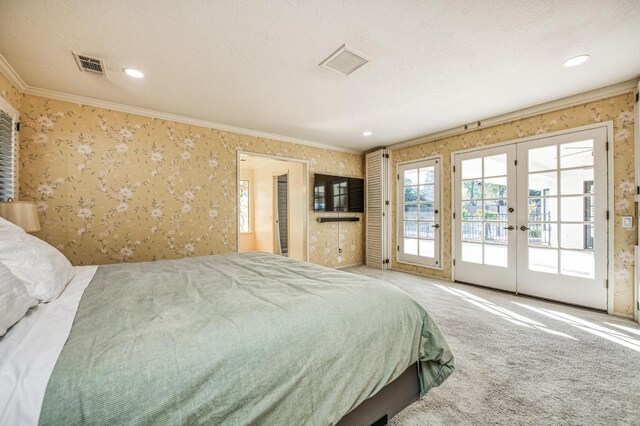 bedroom featuring carpet floors, access to outside, french doors, a textured ceiling, and crown molding