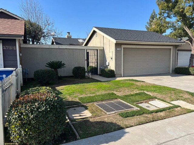 view of front of house with a front lawn and a garage