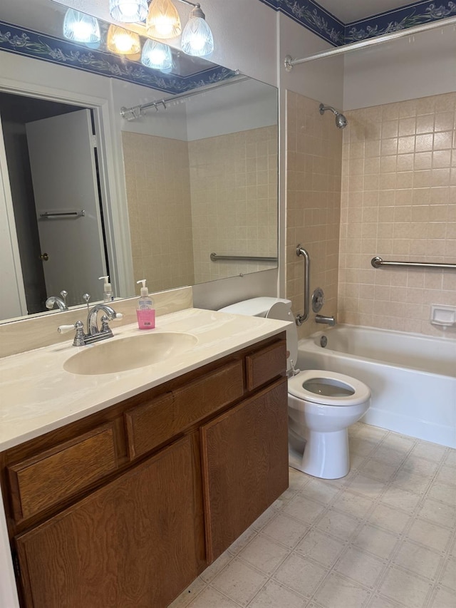 full bathroom featuring toilet, vanity, and tiled shower / bath